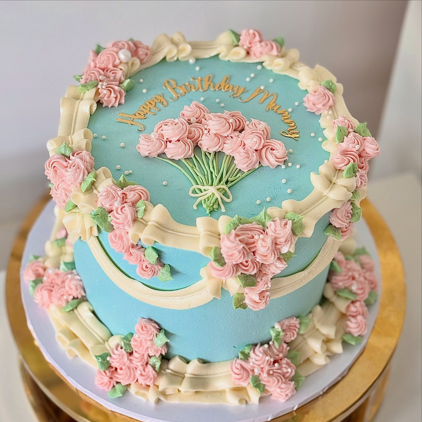 Vintage blue birthday cake with pink piping