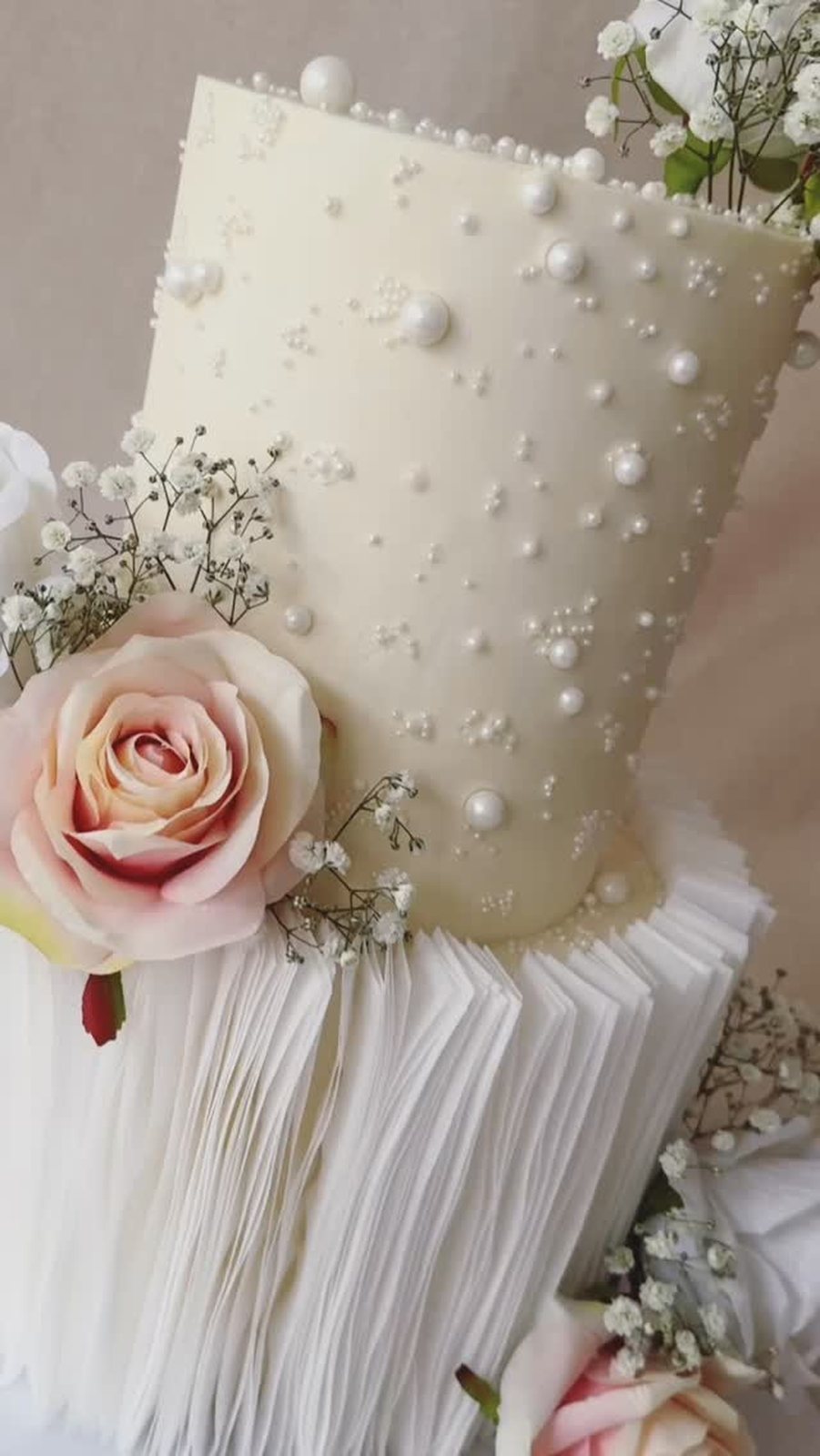 Tall pearl cake with a garden rose