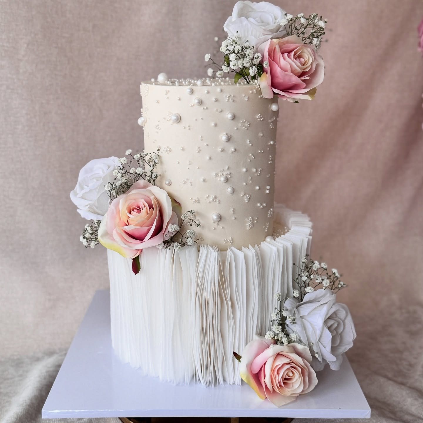 Cream ruffle cake with blush roses