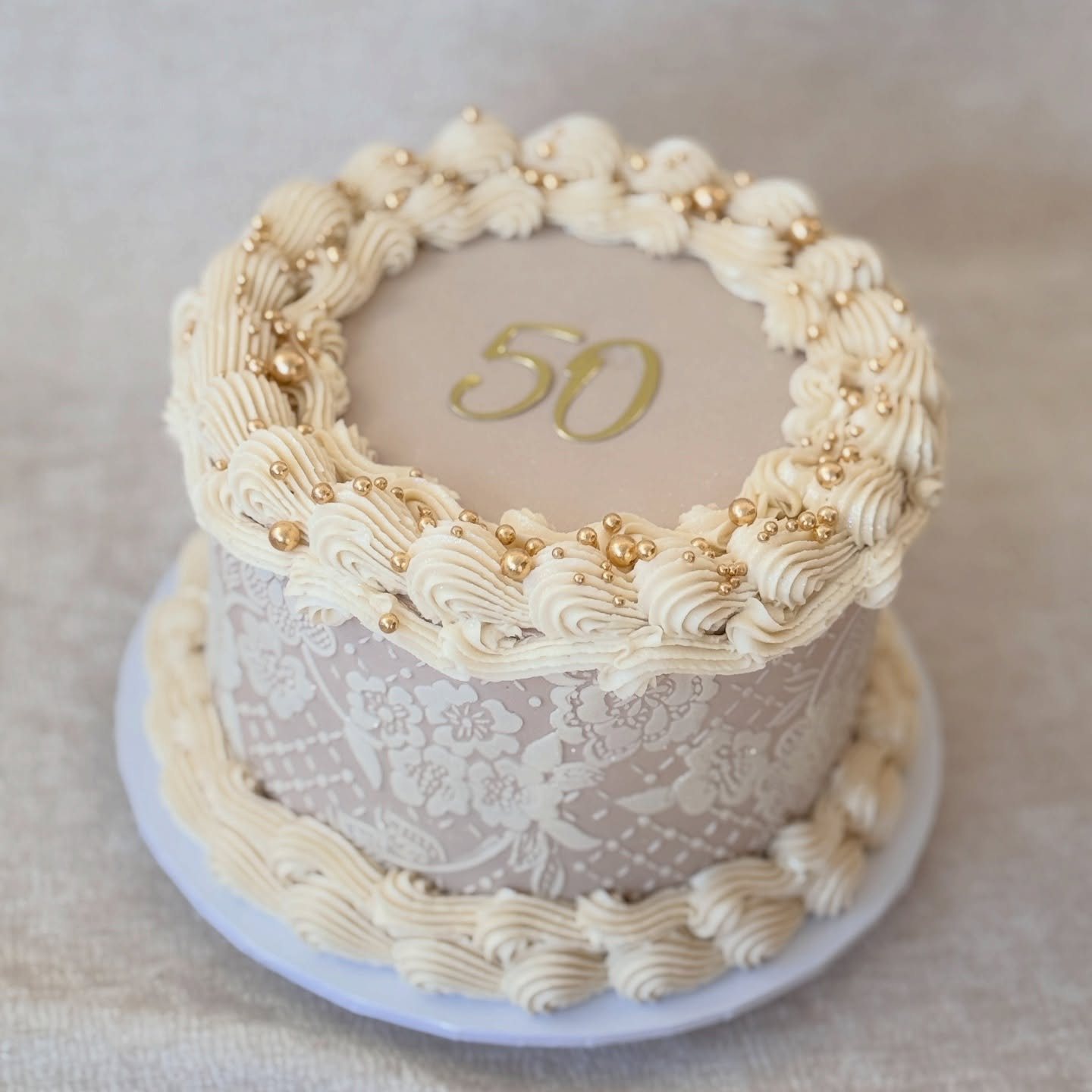 Vintage piped cream cake with delicate shell borders