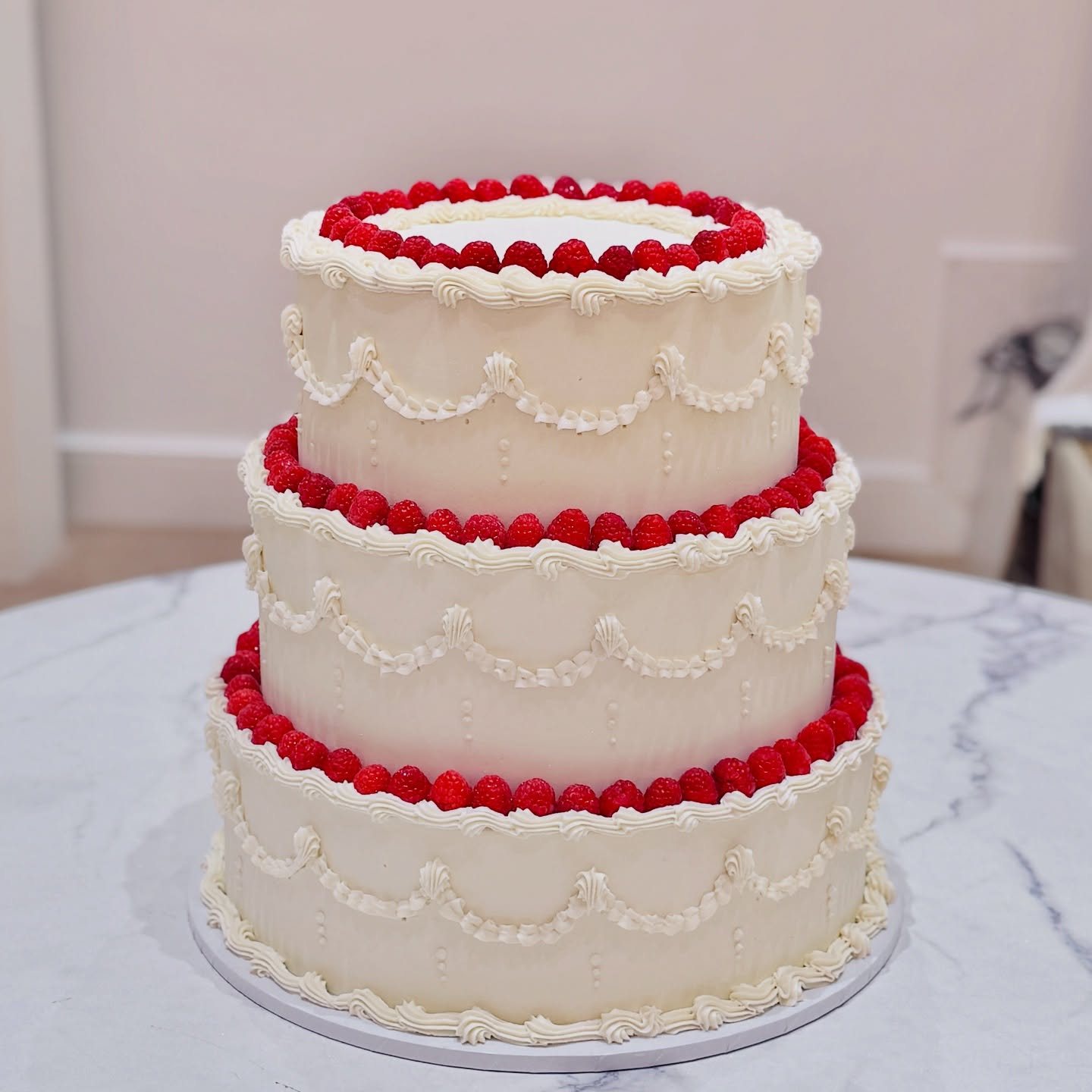 Three tier cake with red ruffle bands